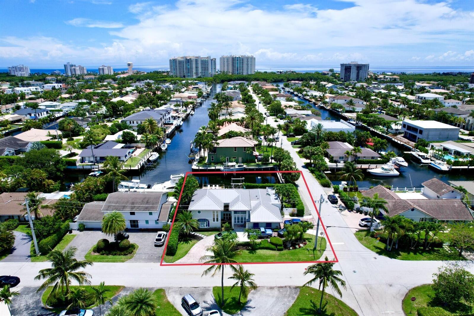 An aerial view shows a waterfront house with a pool and boat dock — 6500 NE 7th Avenue, Boca Raton FL 33487, BOCA RATON, FL