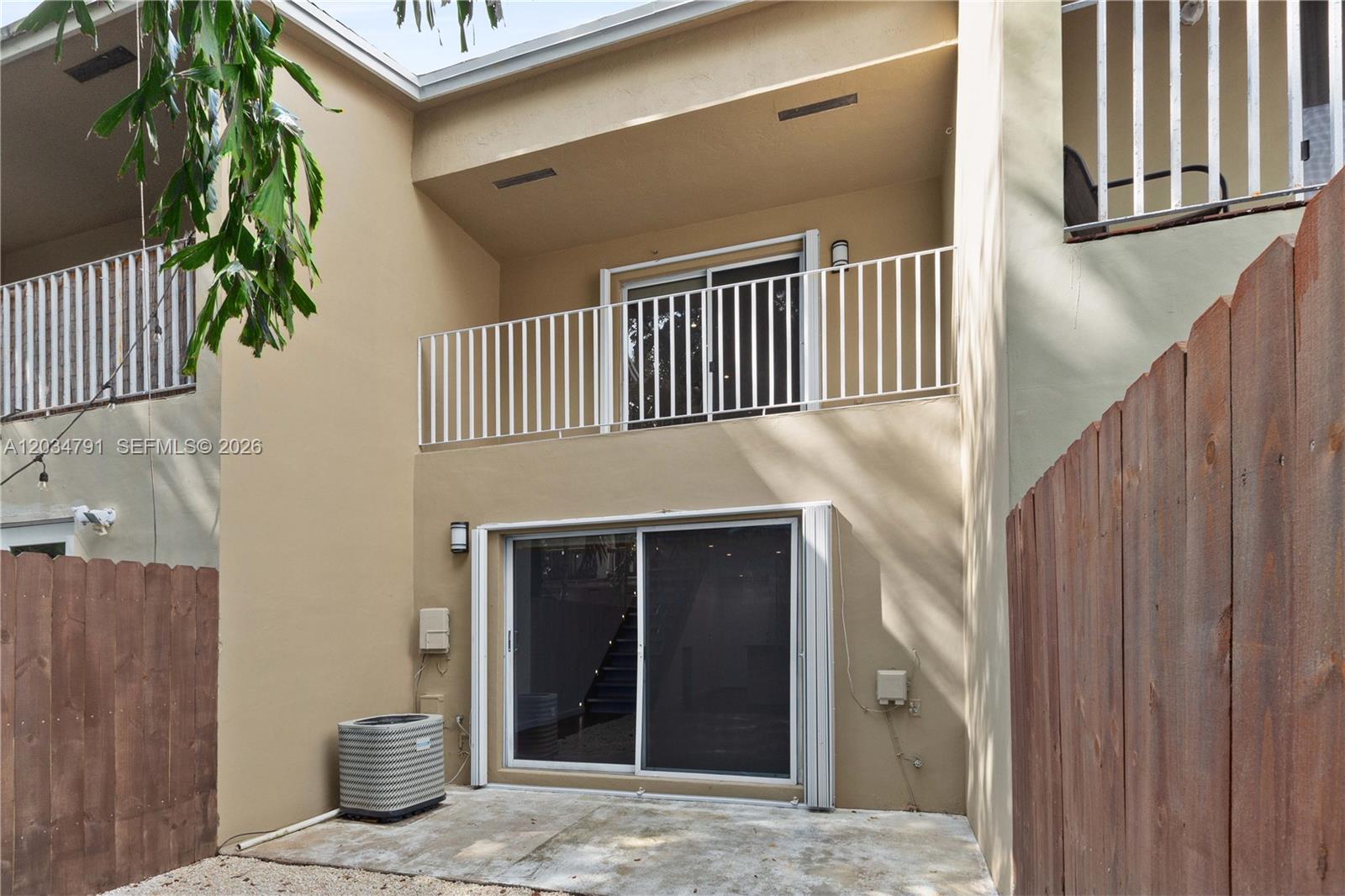 The exterior view shows a two-story building with sliding glass doors and white metal railings — 3130 Bird Ave # 3, Miami FL 33133, MIAMI, FL