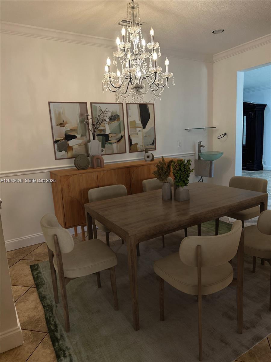 A dining room features a wooden table, upholstered chairs, a chandelier, and a wall-mounted sink — 3701 Starboard Ave, Cooper City FL 33026, COOPER CITY, FL