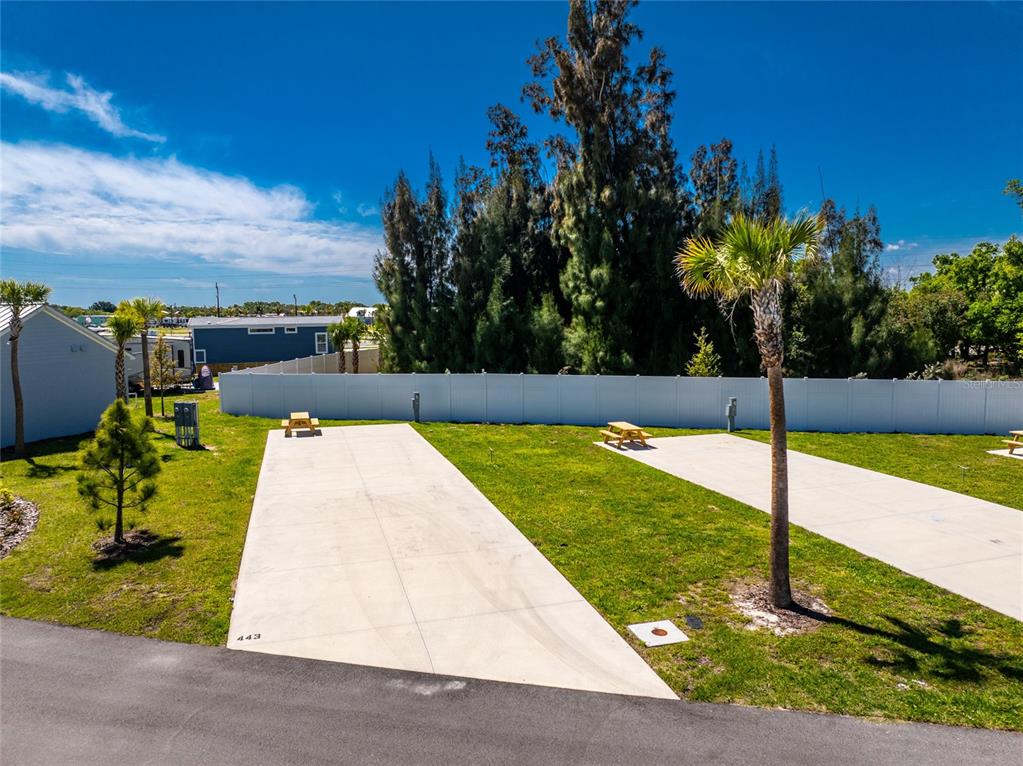 Two concrete RV pads with picnic tables are situated on a grassy lot — 443 HORIZON ROAD, PUNTA GORDA, FL