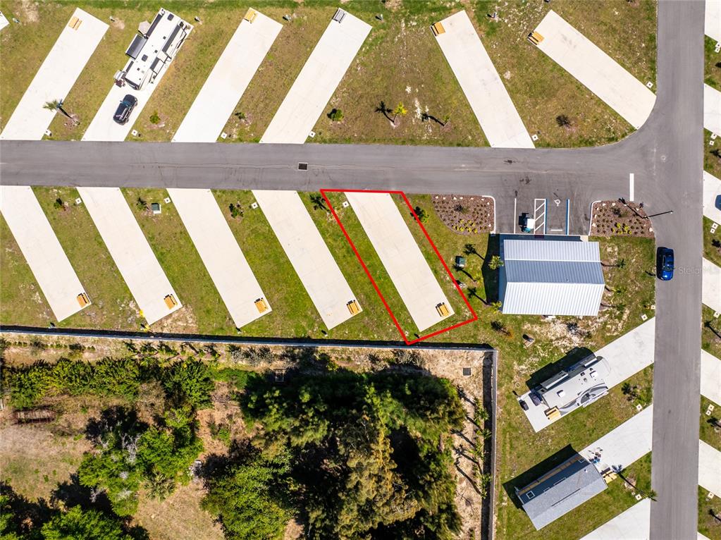 This aerial view shows a paved RV lot outlined in red within a campground — 443 HORIZON ROAD, PUNTA GORDA, FL