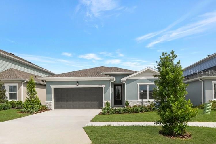 A single-story house with a gray garage, light blue siding, and a stone facade — 11865 MILE MARSH DRIVE, RIVERVIEW, FL