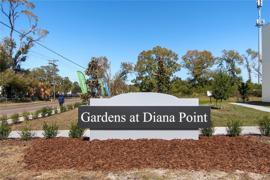 A sign for Gardens at Diana Point stands in a landscaped area near a road — 4348 CAMBIO GARDENS COURT, TAMPA, FL