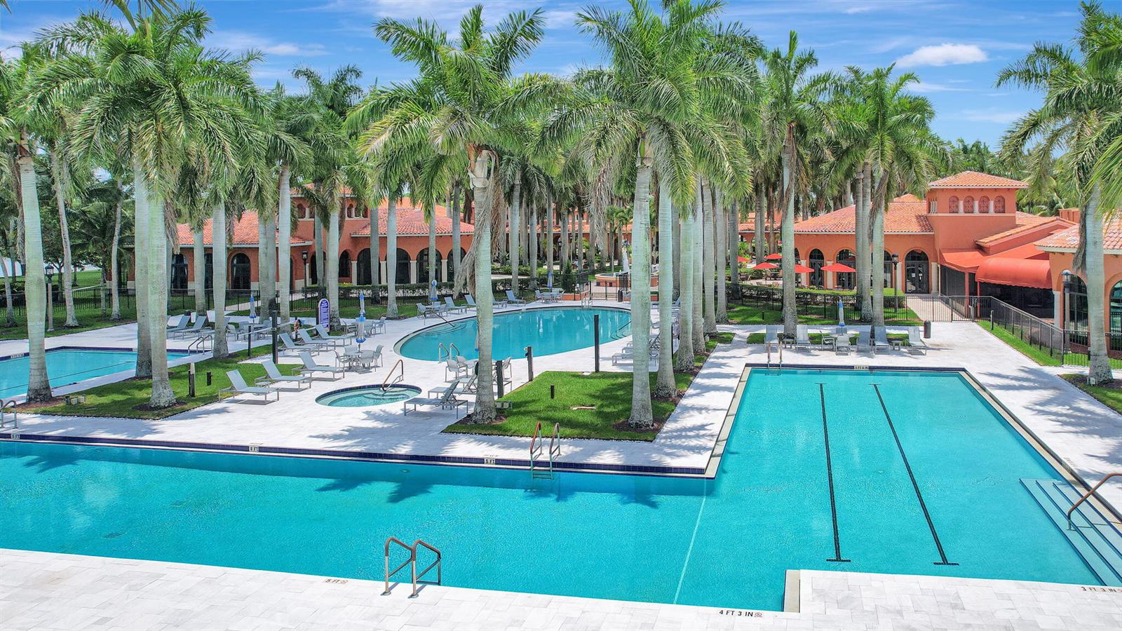 A single-story house with a white stucco facade, a two-car garage, and a paved driveway — 9842 Via Elegante, Wellington FL 33411, WELLINGTON, FL