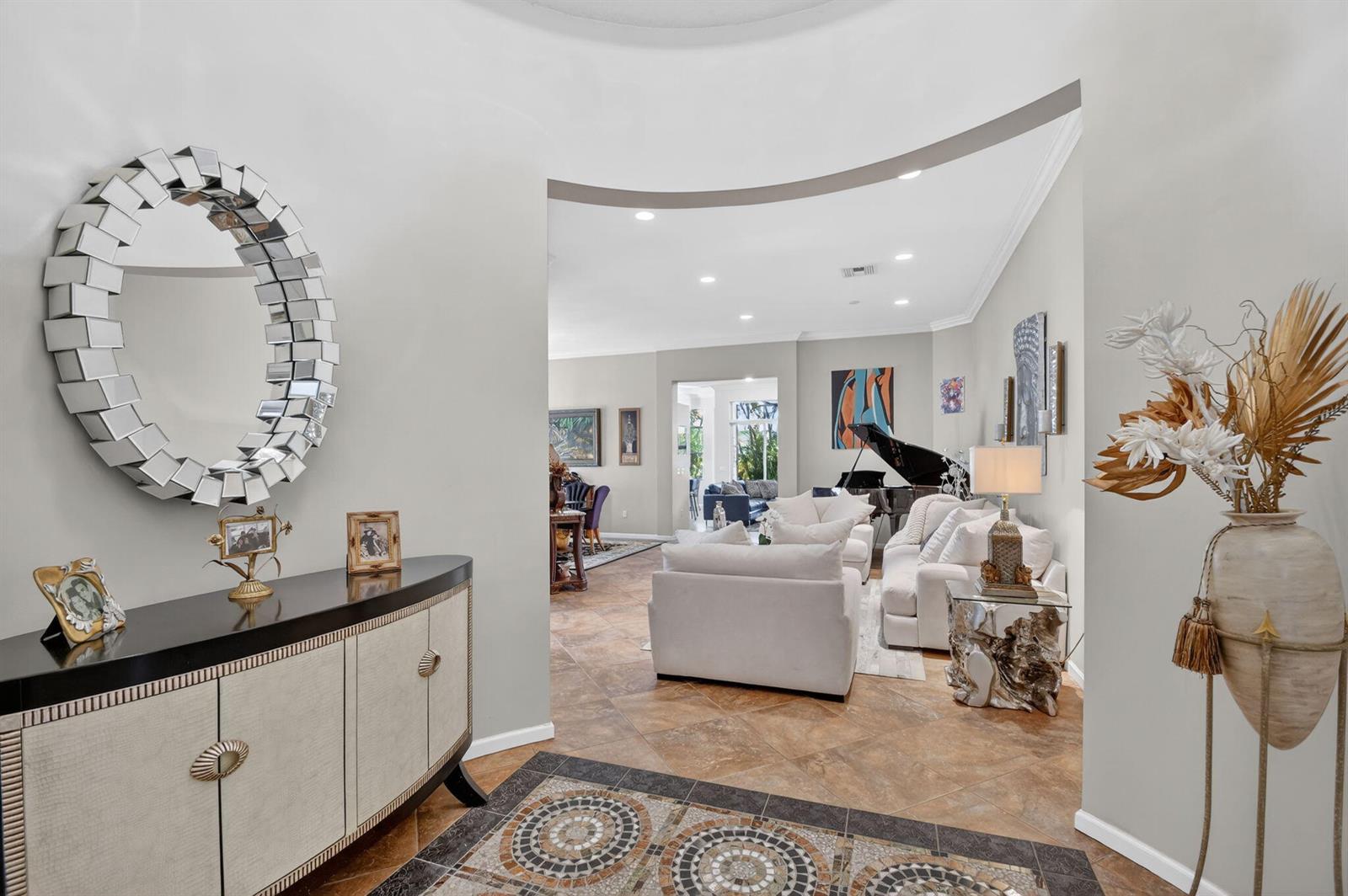 A foyer with a mosaic floor leads into a living room featuring a grand piano — 9842 Via Elegante, Wellington FL 33411, WELLINGTON, FL