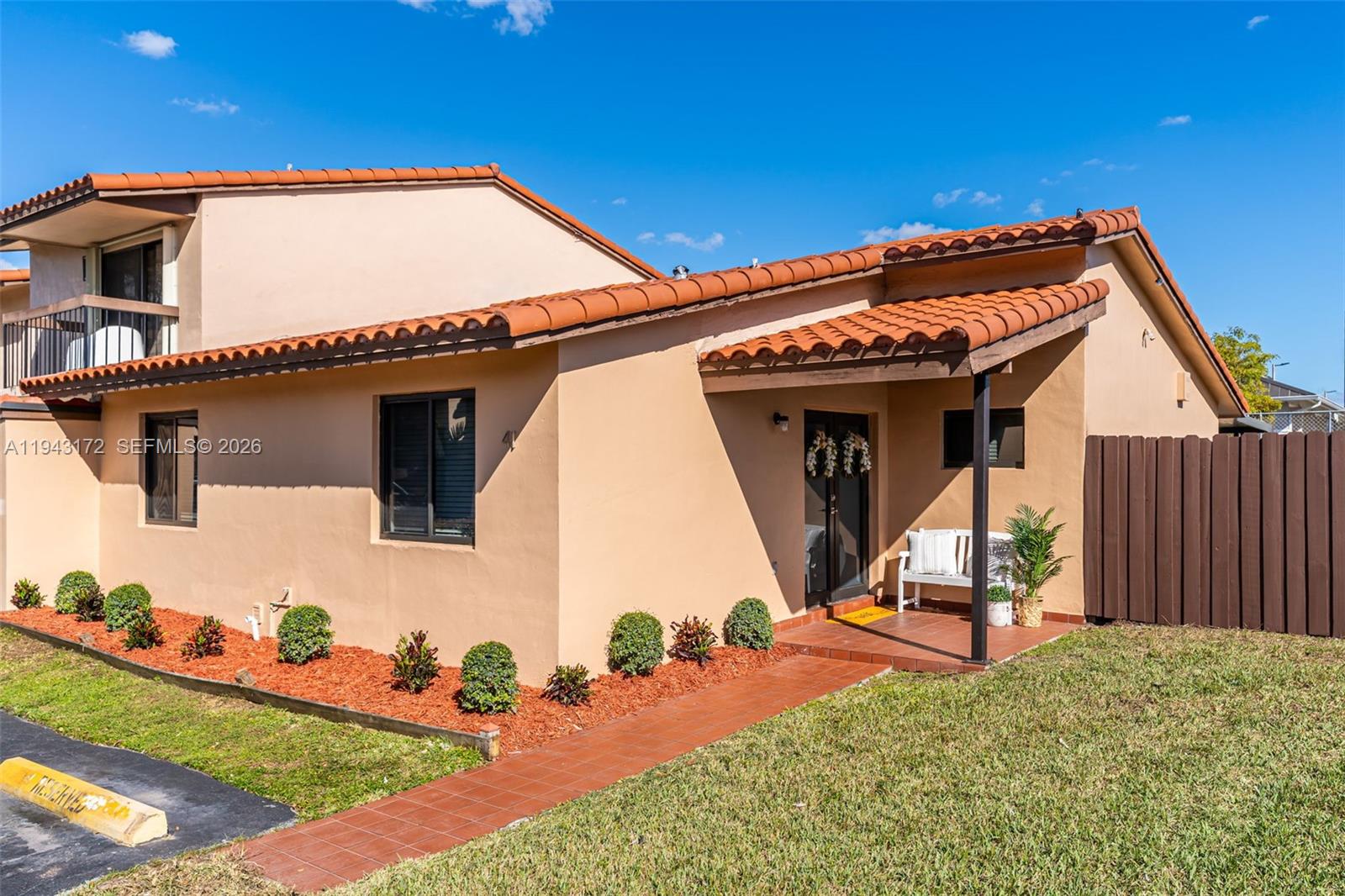 A tan stucco house features a red tile roof, a covered entryway, and landscaped garden beds — 3815 SW 82nd Ave # 41, Miami FL 33155, MIAMI, FL