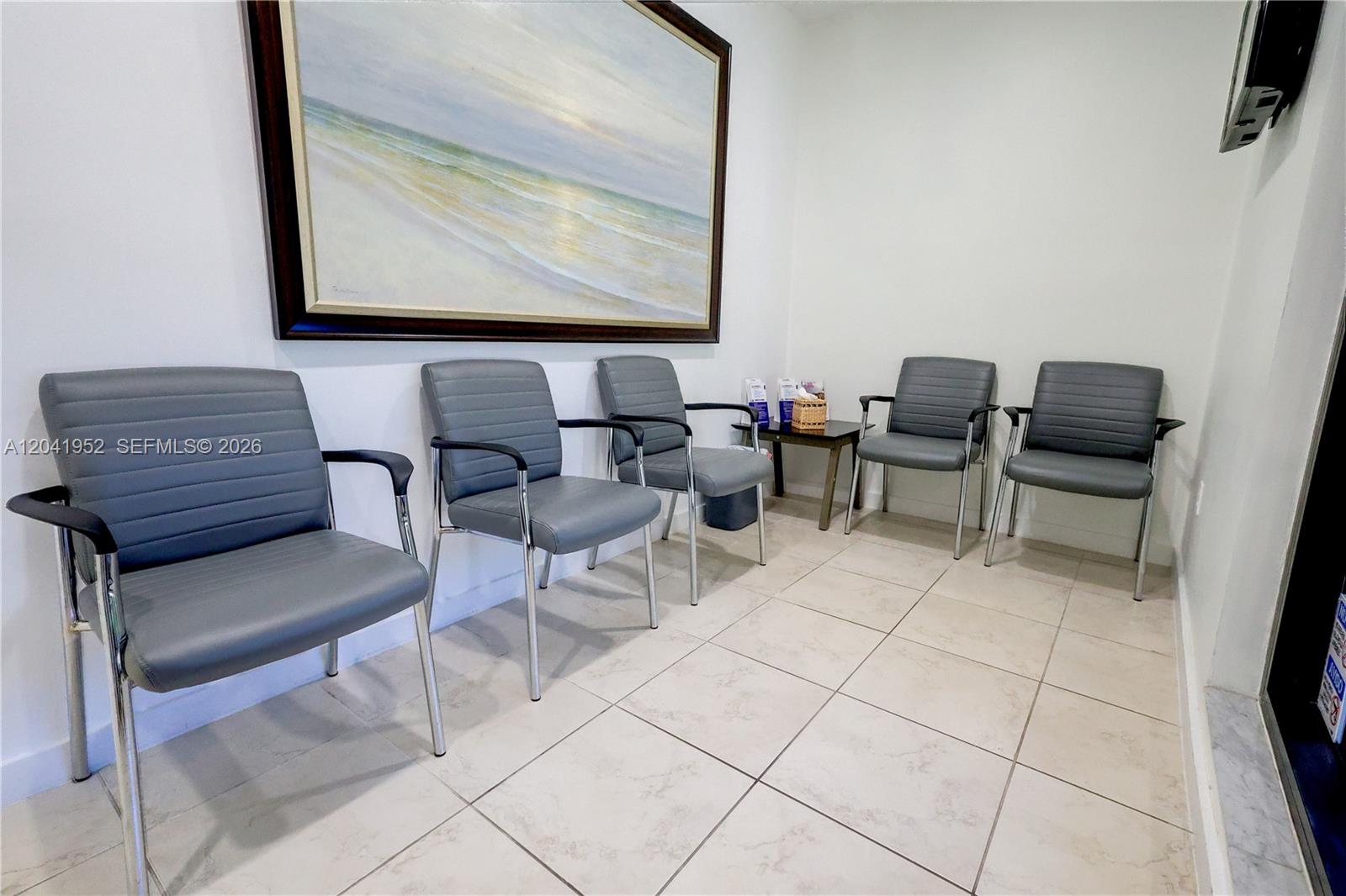 A waiting room features five gray chairs, tiled floors, and a large framed beach painting — 8525 SW 92nd St # 11B, Miami FL 33156, MIAMI, FL