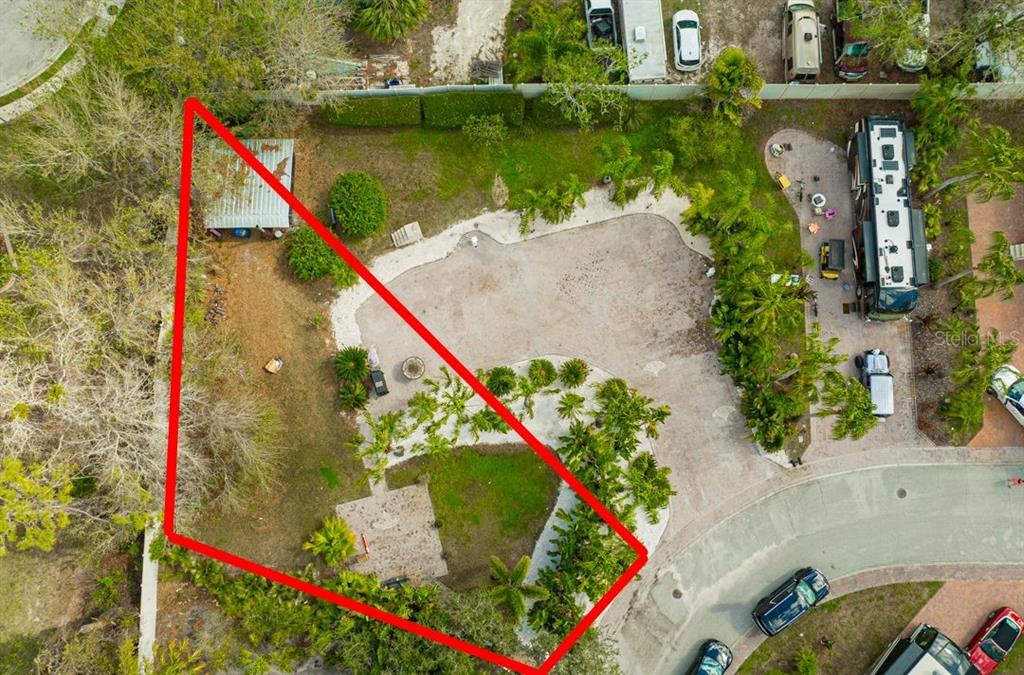 An aerial view shows a landscaped lot with a paved driveway, palm trees, and shed — 6857 AMANDA VISTA CIRCLE, LAND O LAKES, FL