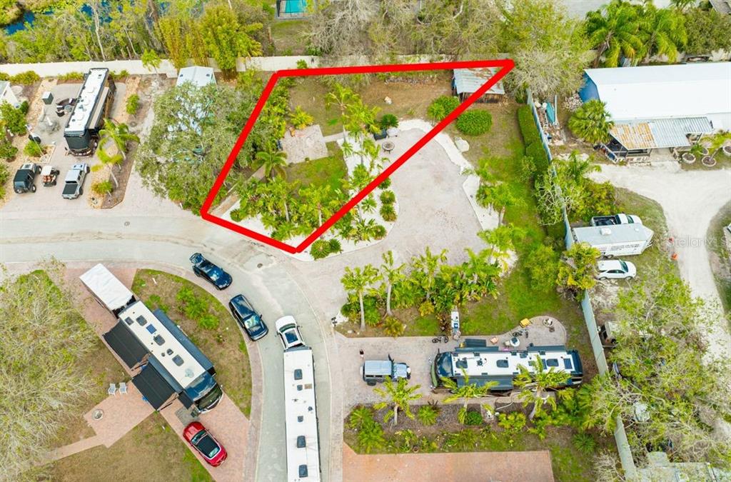 An aerial view shows a landscaped lot with a red outline highlighting the property boundaries — 6857 AMANDA VISTA CIRCLE, LAND O LAKES, FL
