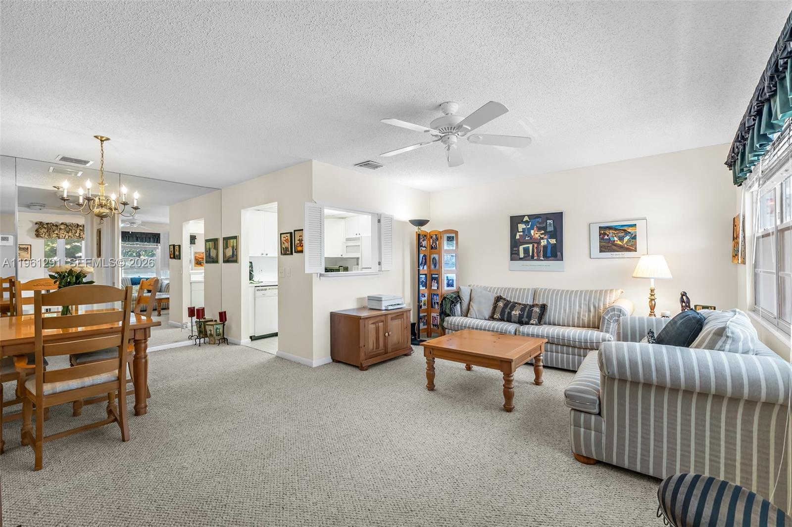 A living room features striped sofas, a wooden coffee table, and an adjacent dining area — 316 Tilford O # 316, Deerfield Beach FL 33442, DEERFIELD BEACH, FL