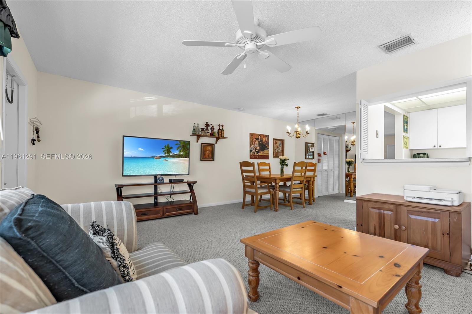 A living and dining area features a ceiling fan, carpeted floors, and wooden furniture — 316 Tilford O # 316, Deerfield Beach FL 33442, DEERFIELD BEACH, FL
