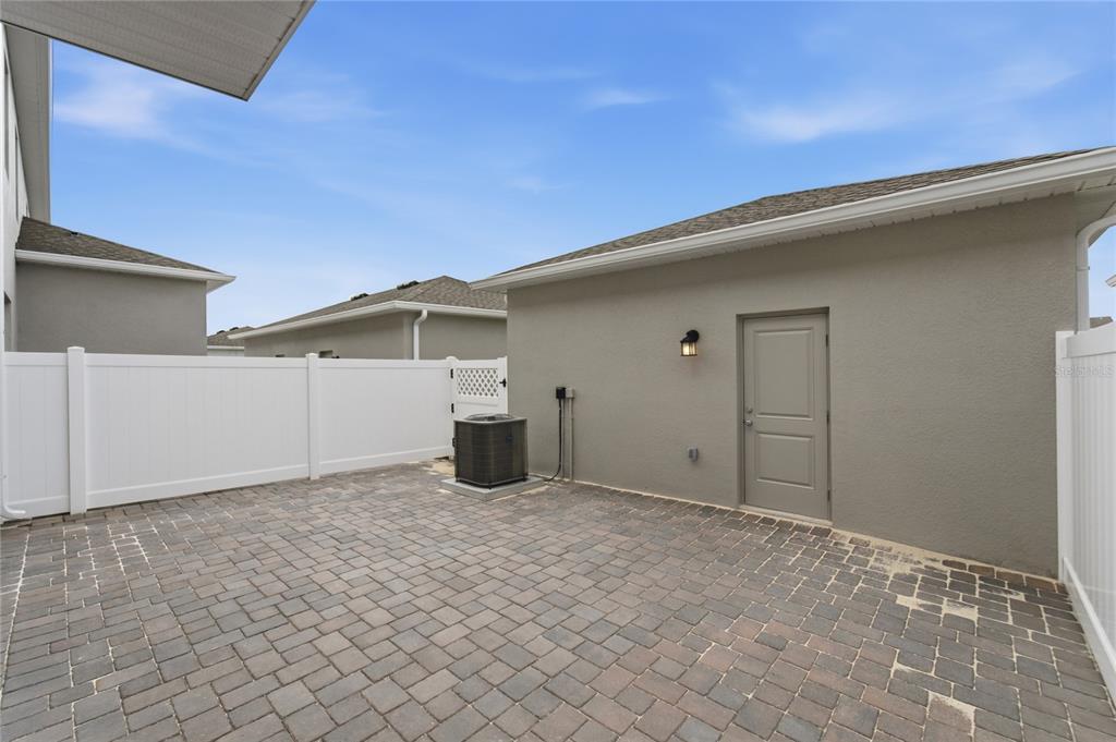 An aerial view shows a suburban neighborhood with multi-family townhomes, a pond, and construction areas — 2164 RIDER RAIN LANE, APOPKA, FL