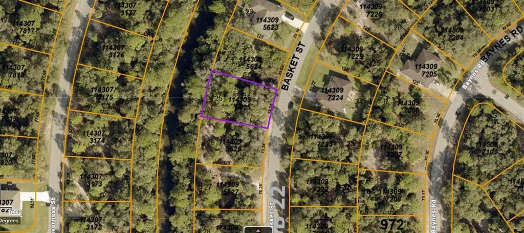 This is a satellite map view of a vacant residential lot outlined in purple — BASKET STREET, NORTH PORT, FL