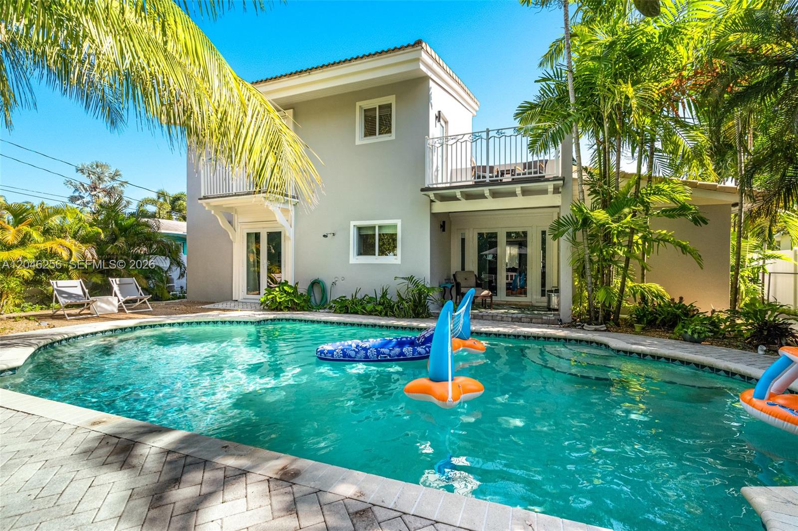 A two-story house with a backyard swimming pool, palm trees, and a second-floor balcony — 517 NE 2nd Pl, Dania Beach FL 33004, DANIA BEACH, FL