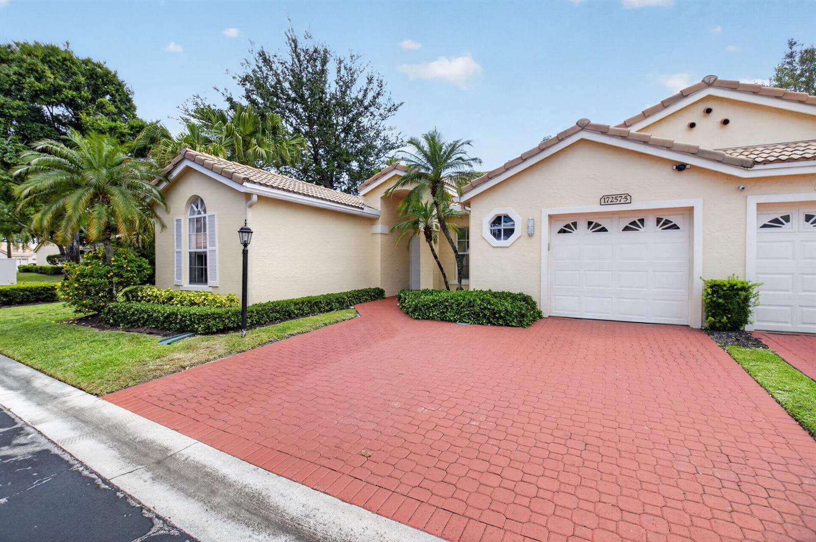 A single-story house with a red paver driveway, palm trees, and a two-car garage — 17257 Boca Club Boulevard Apt 5, Boca Raton FL 33487, BOCA RATON, FL