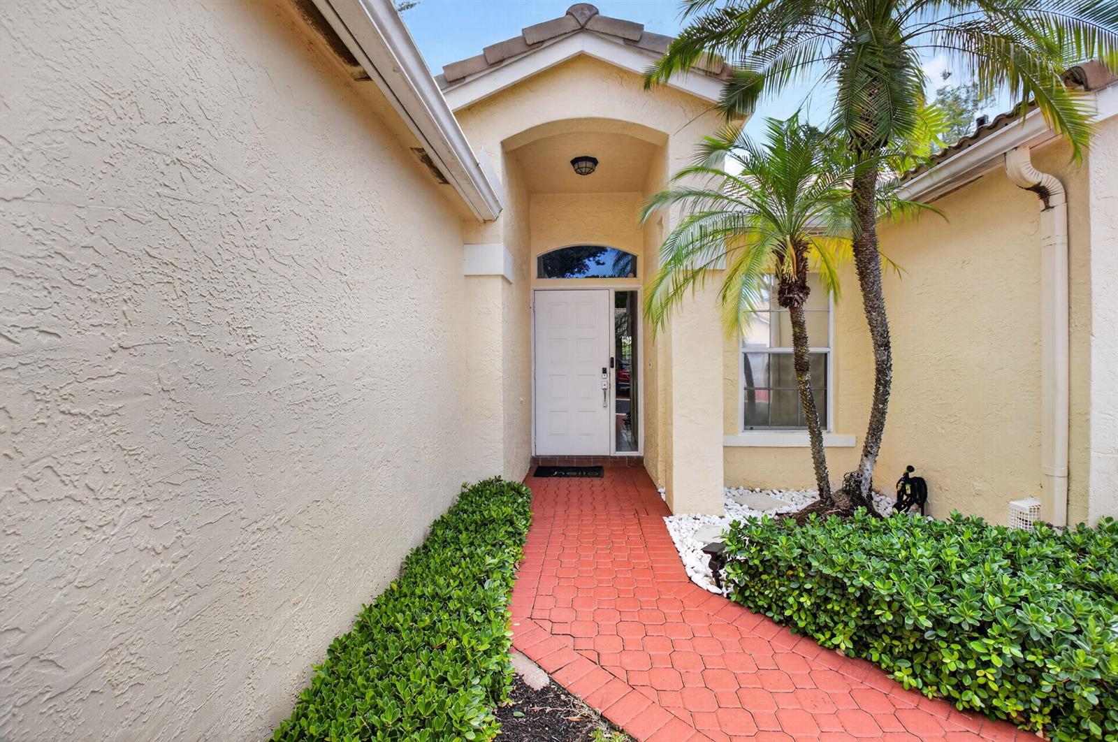 A red brick walkway leads to a white front door under a covered entryway — 17257 Boca Club Boulevard Apt 5, Boca Raton FL 33487, BOCA RATON, FL
