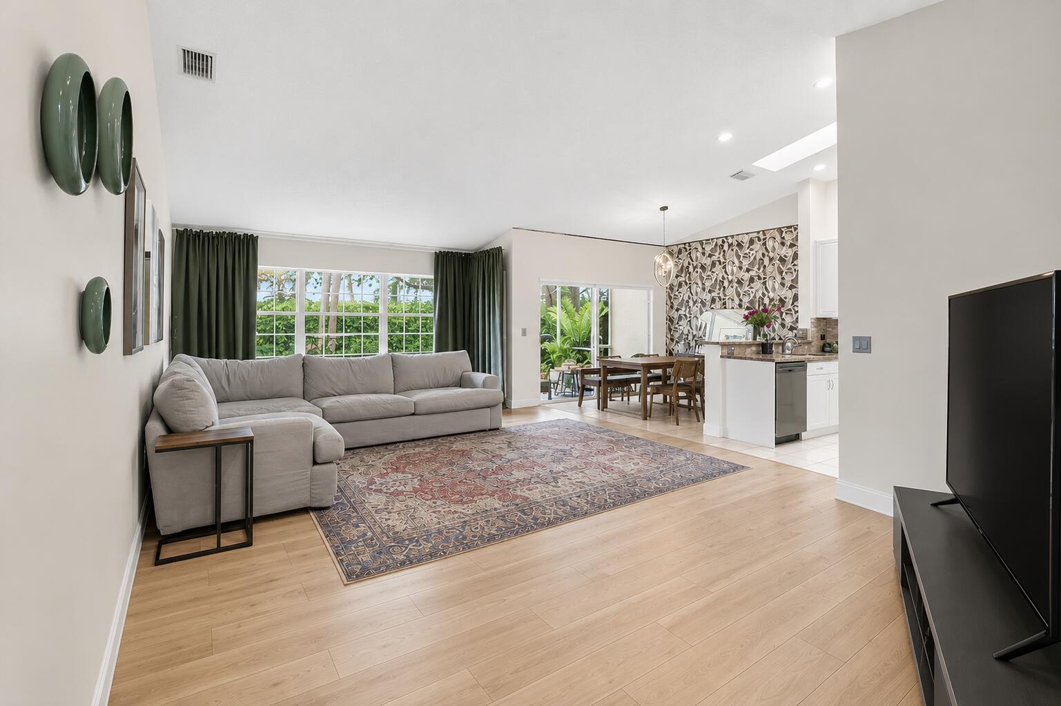 A living room with light wood floors, a gray sectional sofa, and a patterned rug — 17257 Boca Club Boulevard Apt 5, Boca Raton FL 33487, BOCA RATON, FL