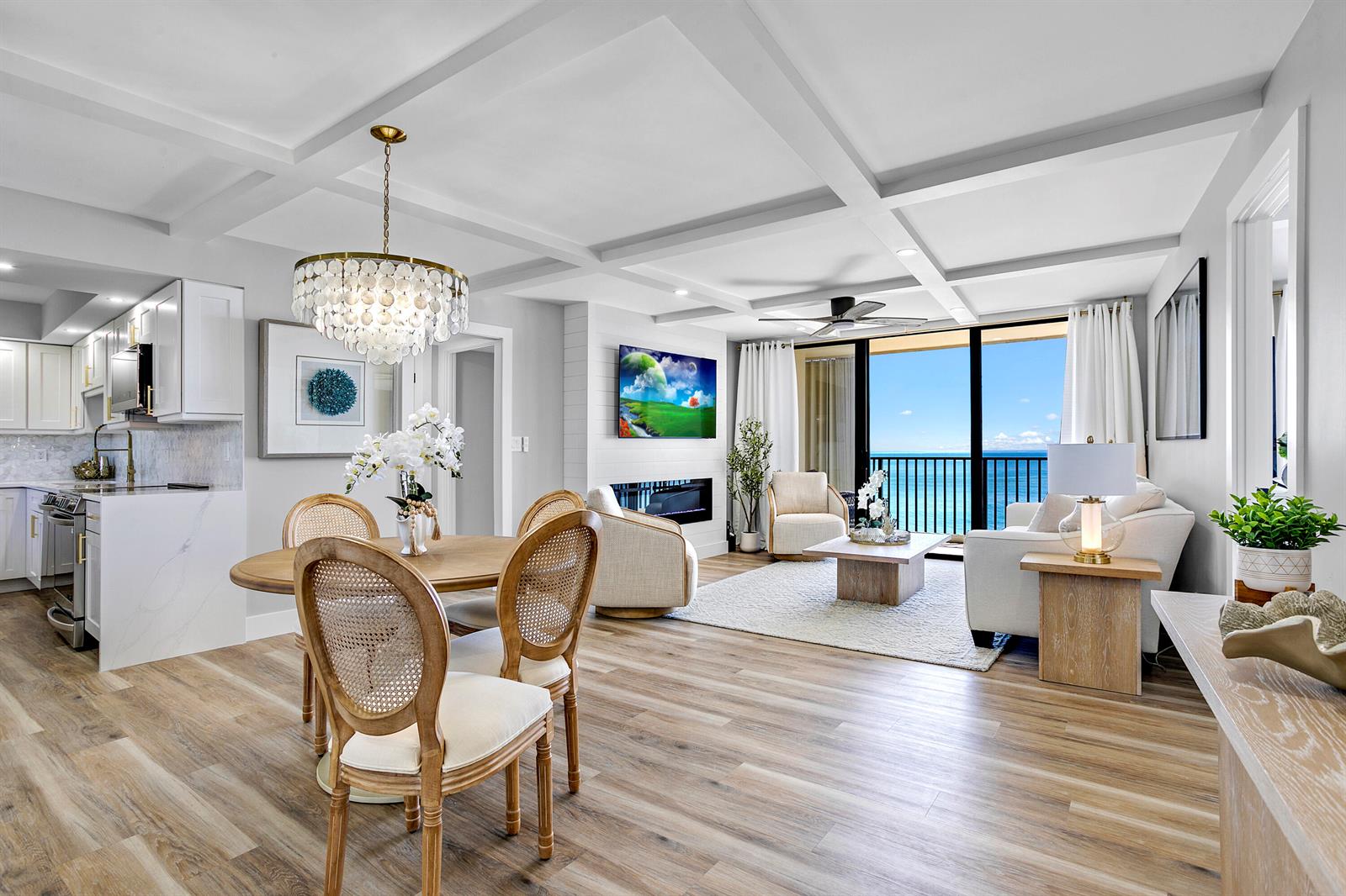 An open-concept living and dining area features light wood floors, a coffered ceiling, and ocean views — 300 Ocean Trail Way # 908, Jupiter FL 33477, JUPITER, FL