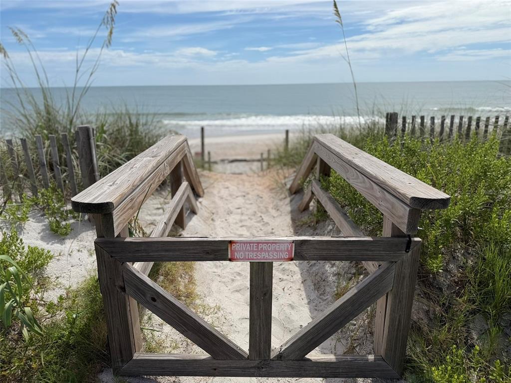 A wooden gate with a no trespassing sign leads to a sandy beach path — 00 S OCEAN SHORE BOULEVARD, FLAGLER BEACH, FL