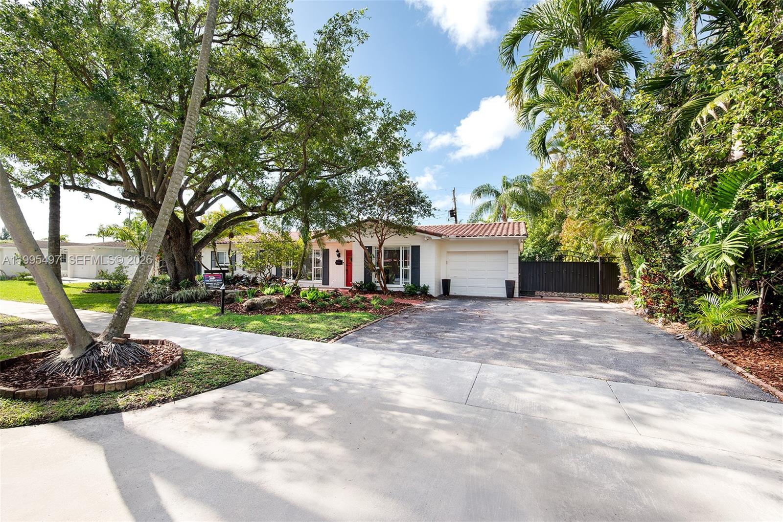 A single-story house with a white exterior, red front door, and attached garage — 9370 SW 82nd St, Miami FL 33173, MIAMI, FL