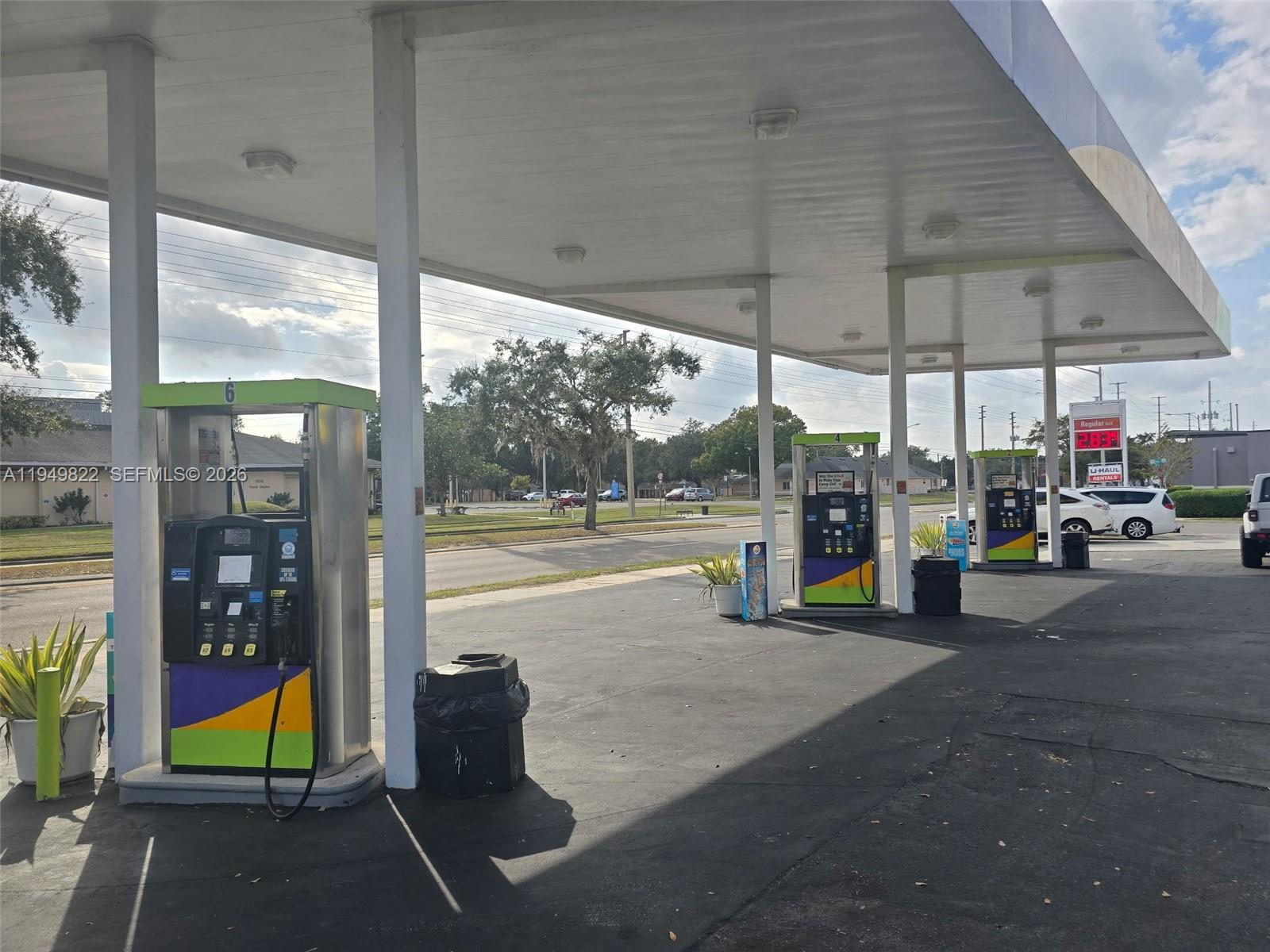 A gas station exterior features multiple fuel pumps under a large white canopy — Confidential, Orlando FL 32806, ORLANDO, FL