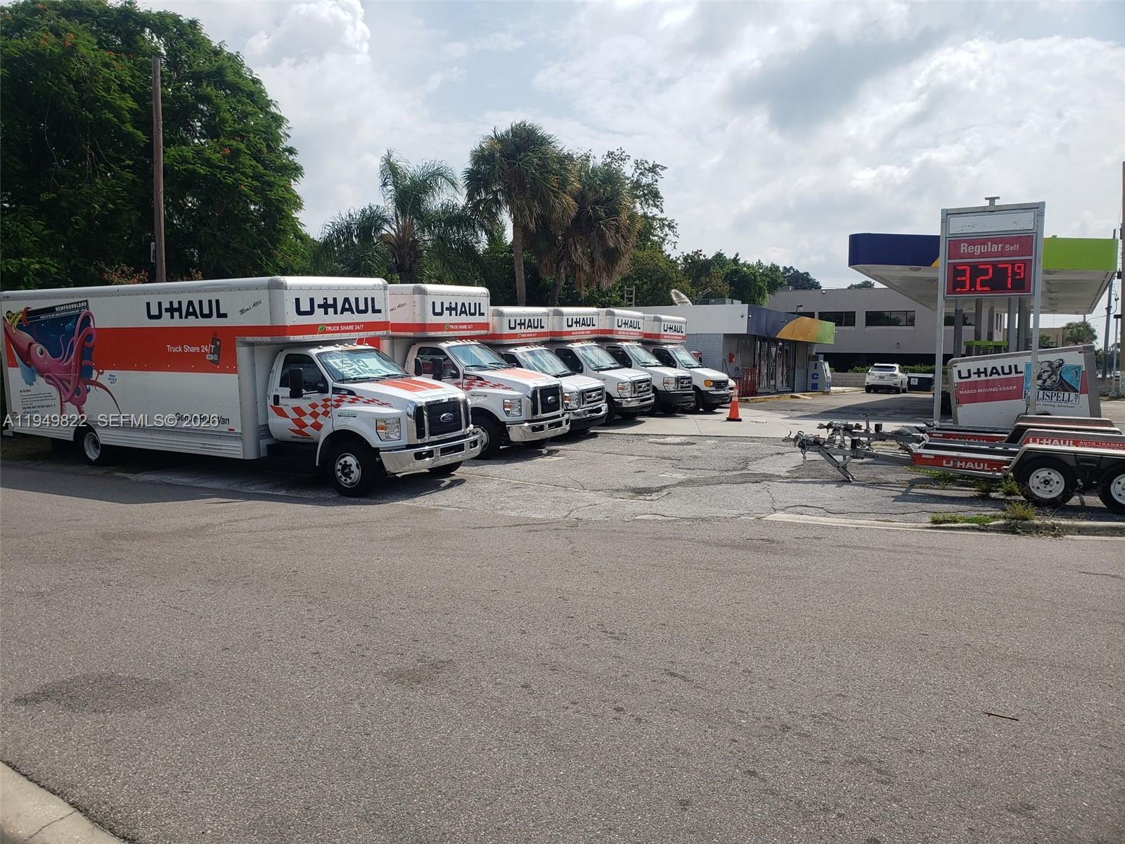 A row of U-Haul trucks is parked in a paved lot next to a gas station — Confidential, Orlando FL 32806, ORLANDO, FL