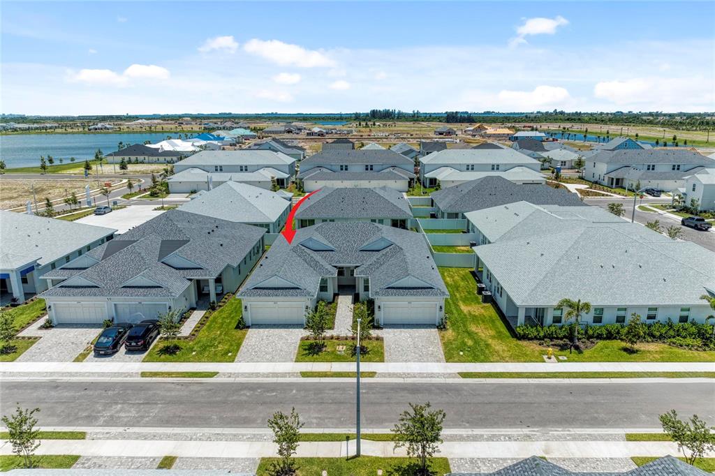 An aerial view shows a row of modern suburban houses with gray roofs and driveways — 8212 CALLAHAN AVENUE, BRADENTON, FL
