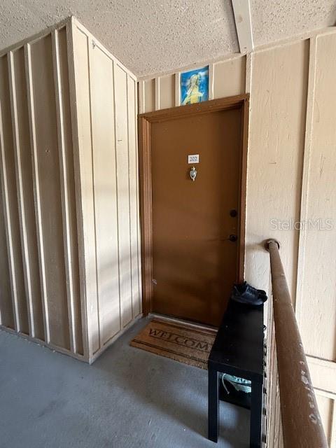 An exterior view of a brown apartment door labeled 202 with a welcome mat — 444 BANYON TREE CIRCLE UNIT 202, MAITLAND, FL