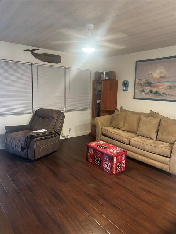 A living room features dark wood flooring, a recliner, a sofa, and a Route 66 ottoman — 133 BERKSHIRE UNIT 133, WEST PALM BEACH, FL