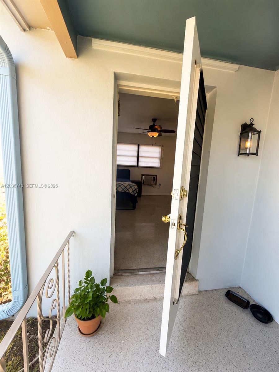 A view through an open door into a bedroom with a ceiling fan — 3202 Pierce St, Hollywood FL 33021, HOLLYWOOD, FL