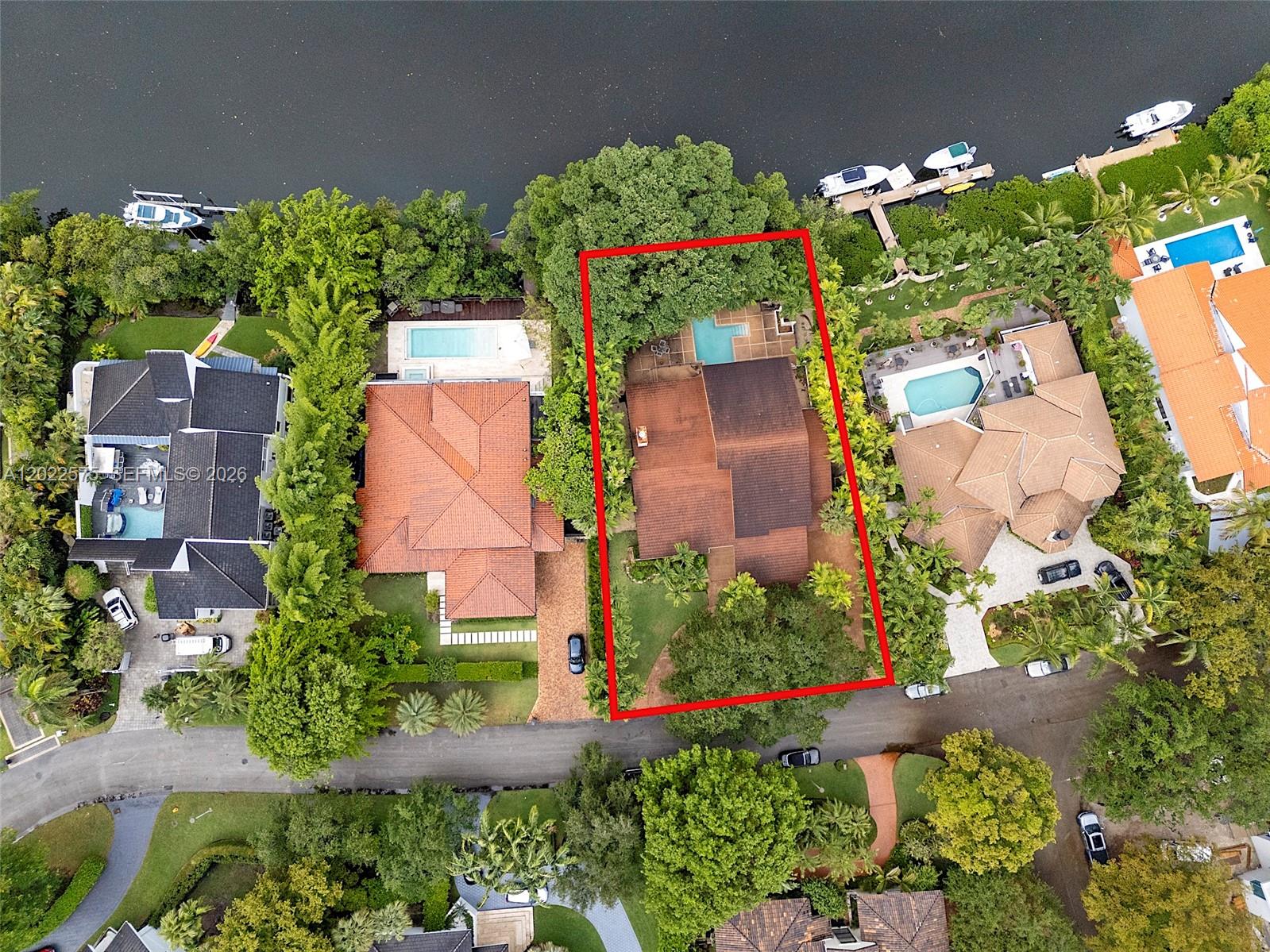 Aerial view of a residential property with a swimming pool and waterfront access — 7244 E Lago Dr, Coral Gables FL 33143, CORAL GABLES, FL