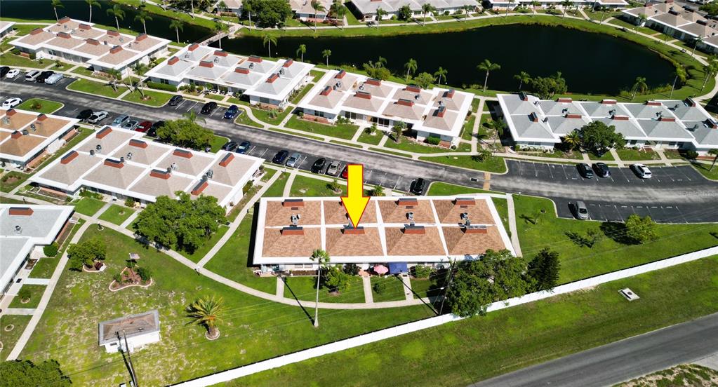An aerial view shows a residential complex with a yellow arrow pointing to a unit — 4337 TAHITIAN GARDENS CIRCLE UNIT F, HOLIDAY, FL