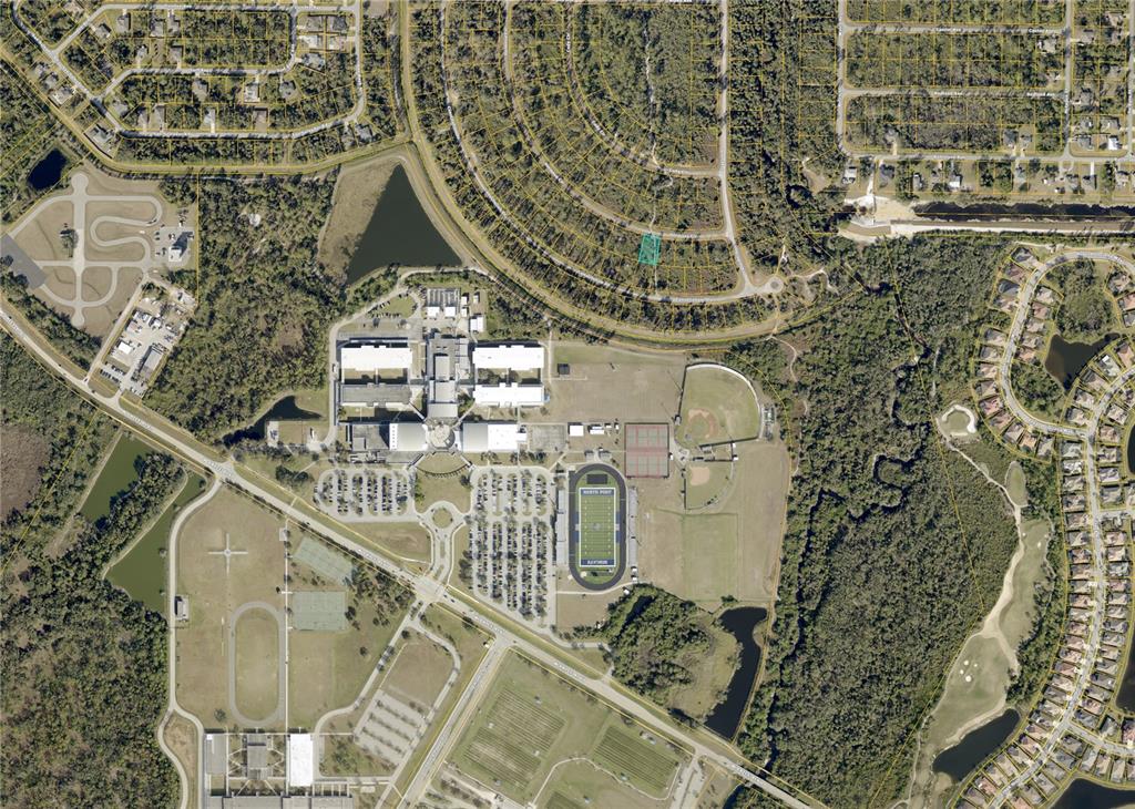 This is an aerial map showing a residential lot highlighted in green near a school — HERMOSA (LOT 5) CIRCLE, NORTH PORT, FL