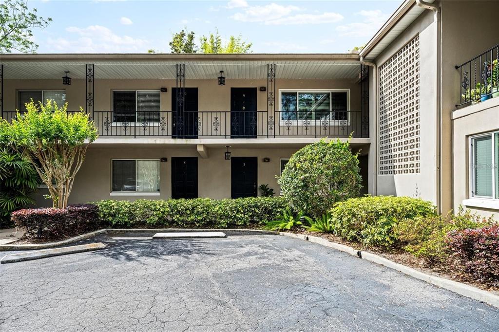 A two-story apartment building exterior features a paved parking area and landscaped bushes — 644 N KNOWLES AVENUE UNIT 3, WINTER PARK, FL