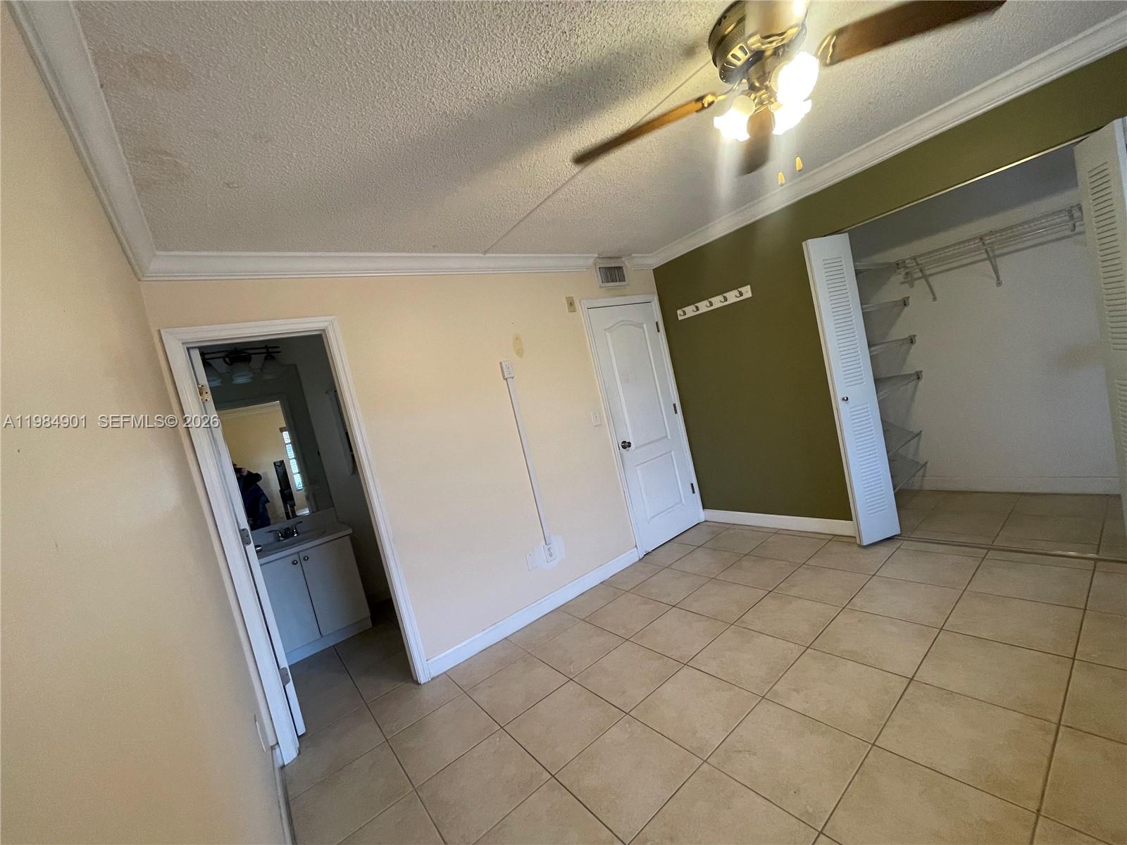 A bedroom features tile flooring, a ceiling fan, a closet, and an attached bathroom — 8600 SW 109th Ave # 220, Miami FL 33173, MIAMI, FL