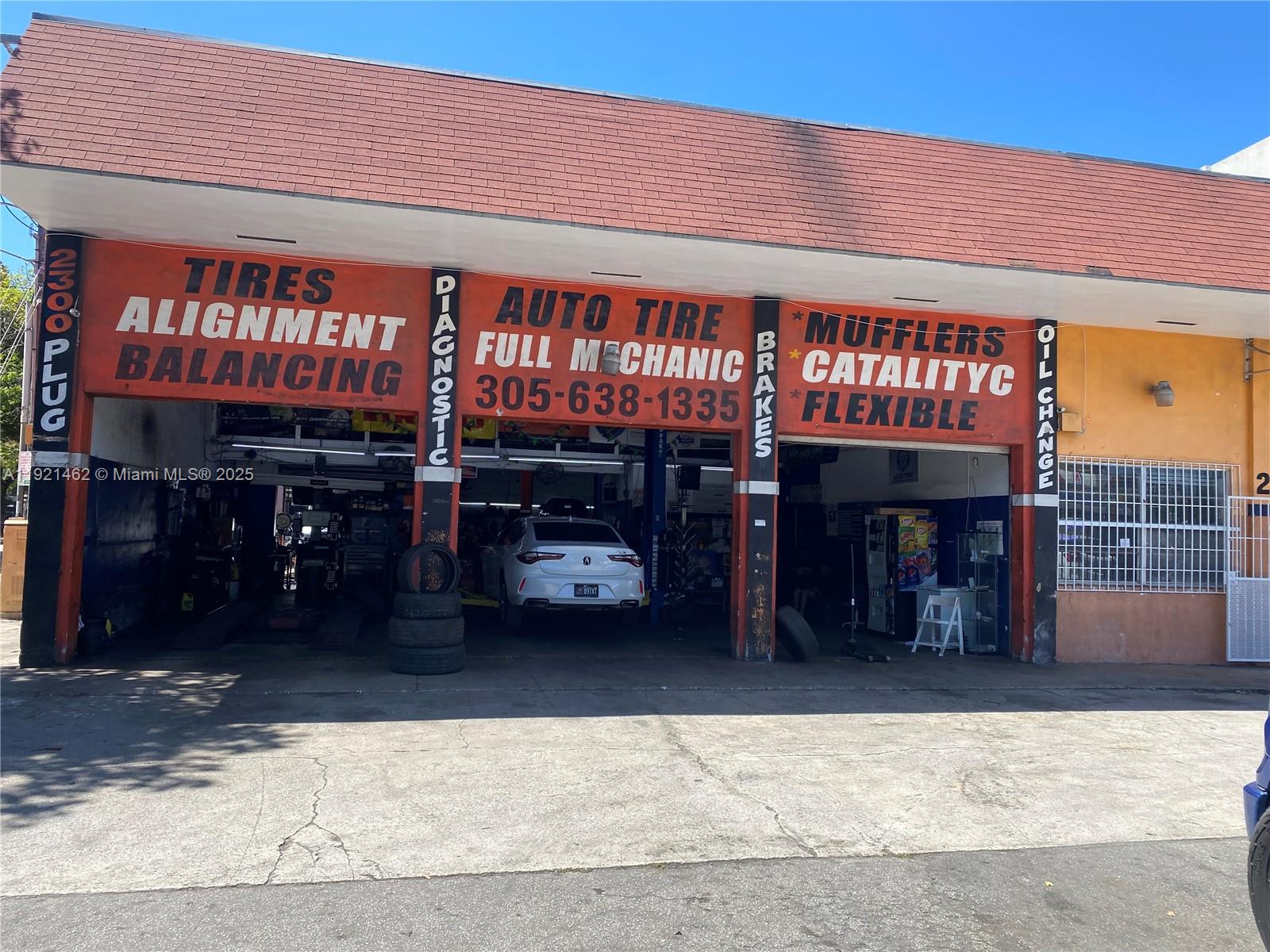 The exterior of an auto repair shop features multiple service bays and signage for automotive services — 2300 NW 17th St, Miami FL 33142, MIAMI, FL