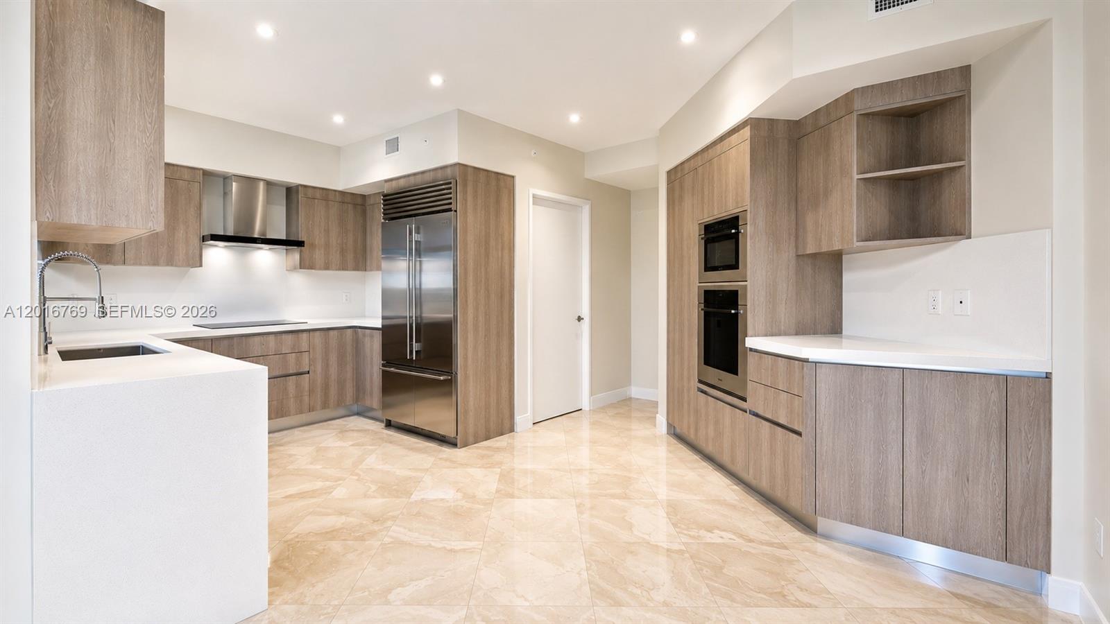 A bright living room features white sofas, a dark leather ottoman, and two wooden armchairs — 737 Crandon Blvd # 402, Key Biscayne FL 33149, KEY BISCAYNE, FL