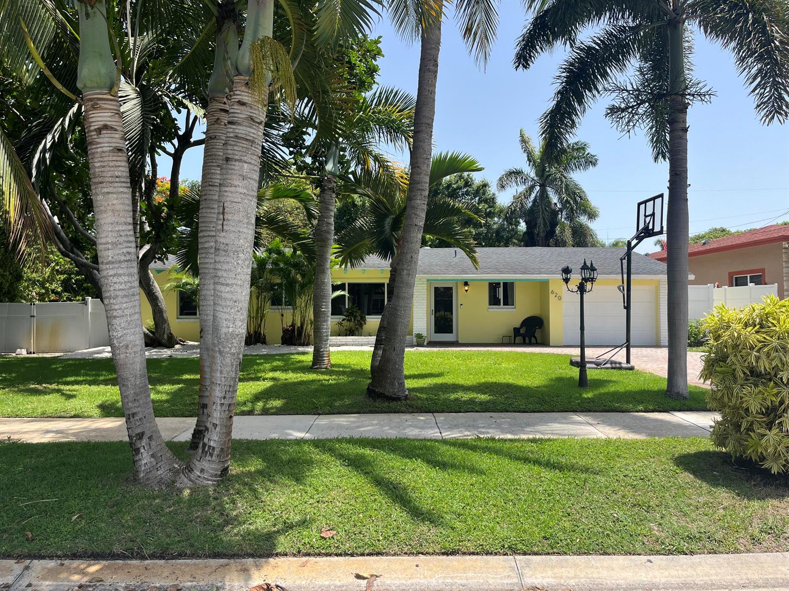 A yellow single-story house with a white garage and palm trees in the front yard — 620 NE 9th Avenue, Boynton Beach FL 33435, BOYNTON BEACH, FL