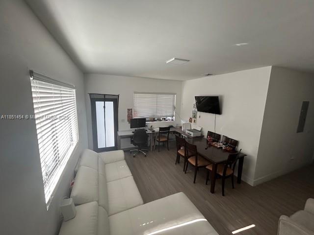 A living room features a white sectional sofa, a dining table, and a computer desk — 3066 NW 92nd St, Miami FL 33147, MIAMI, FL