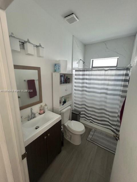 A bathroom features a vanity, a toilet, a storage unit, and a shower with curtains — 3066 NW 92nd St, Miami FL 33147, MIAMI, FL
