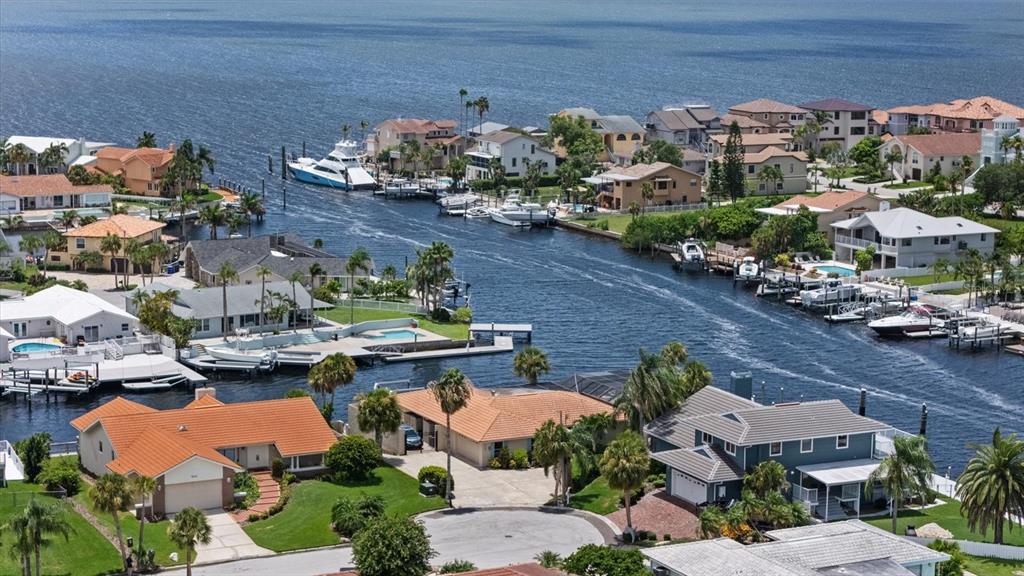 An aerial view of a waterfront house with a screened pool and a private dock — 3154 TRIDENT TERRACE, NEW PORT RICHEY, FL