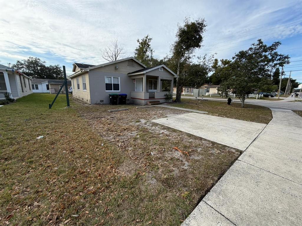 A single-story house with a small front porch and a concrete driveway sits on a lot — 930 18TH STREET UNIT A, ORLANDO, FL
