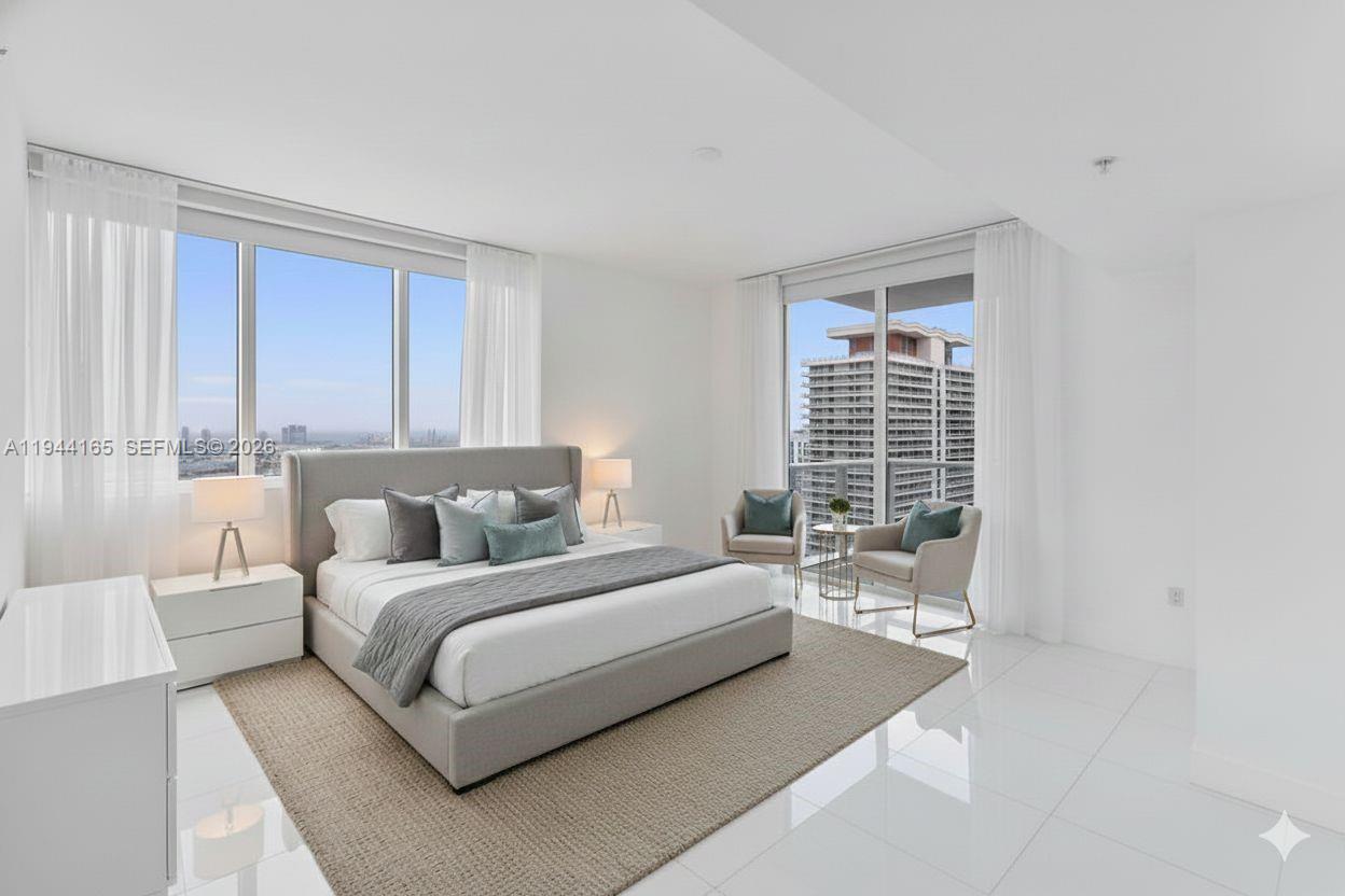 A modern bedroom features a king bed, white tile floors, and floor-to-ceiling windows with city views — 253 NE 2nd St # 4608, Miami FL 33132, MIAMI, FL