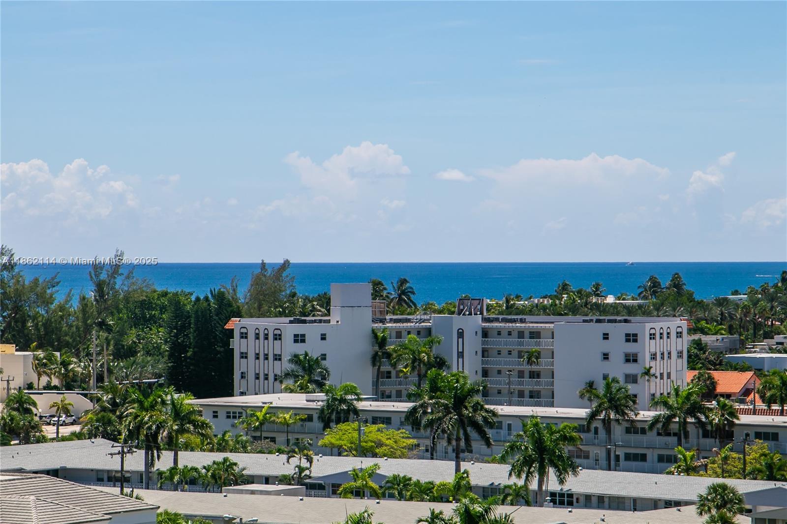An elevated view shows multi-story apartment buildings surrounded by palm trees with the ocean beyond — 2017 S Ocean Dr # 1008, Hallandale Beach FL 33009, HALLANDALE BEACH, FL