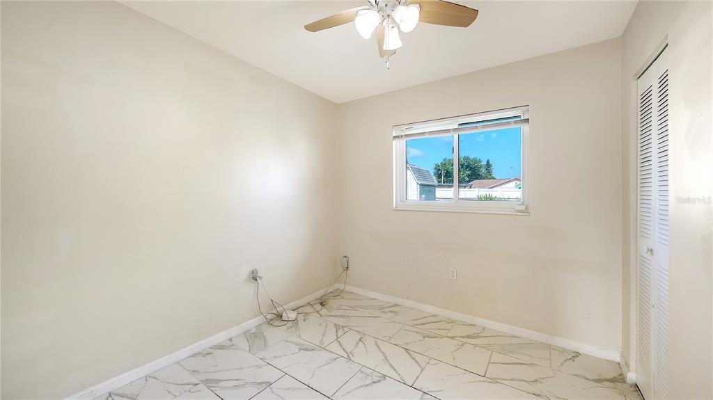 A single-story house with a tan stucco exterior, a front carport, and a concrete driveway — 3307 NEWTOWN BOULEVARD, SARASOTA, FL