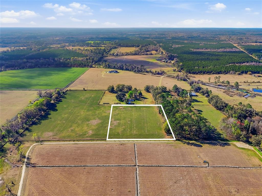 An aerial view shows a rectangular plot of land outlined in white amidst rural fields — TBD NW COUNTY RD 239, ALACHUA, FL