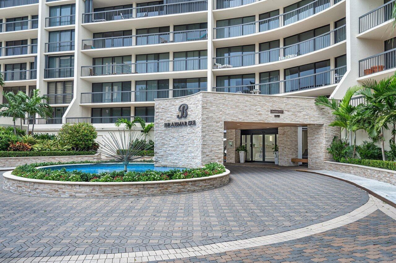 A stone-clad entrance portico with a circular fountain sits before a multi-story residential building — 4740 S Ocean Boulevard # 1515, Highland Beach FL 33487, HIGHLAND BEACH, FL