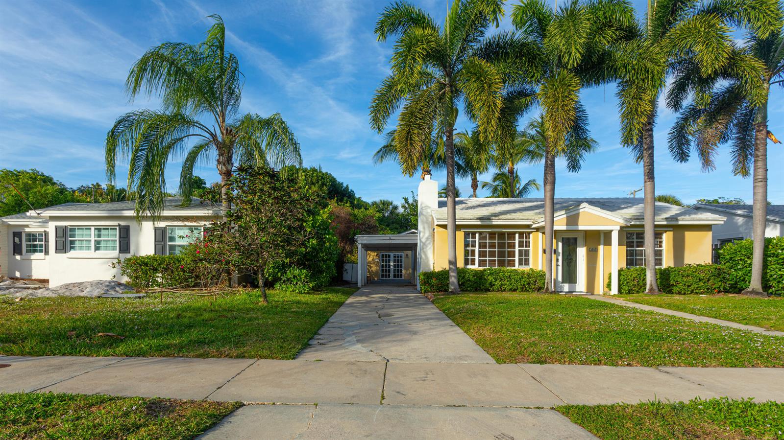 Two single-story houses with a shared driveway and palm trees under a blue sky — 245 Cortez Road, West Palm Beach FL 33405, WEST PALM BEACH, FL