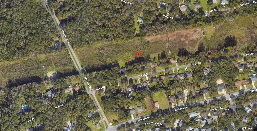 This is an aerial map view showing a residential area with streets and wooded lots — 242 TOMS ROAD, DEBARY, FL