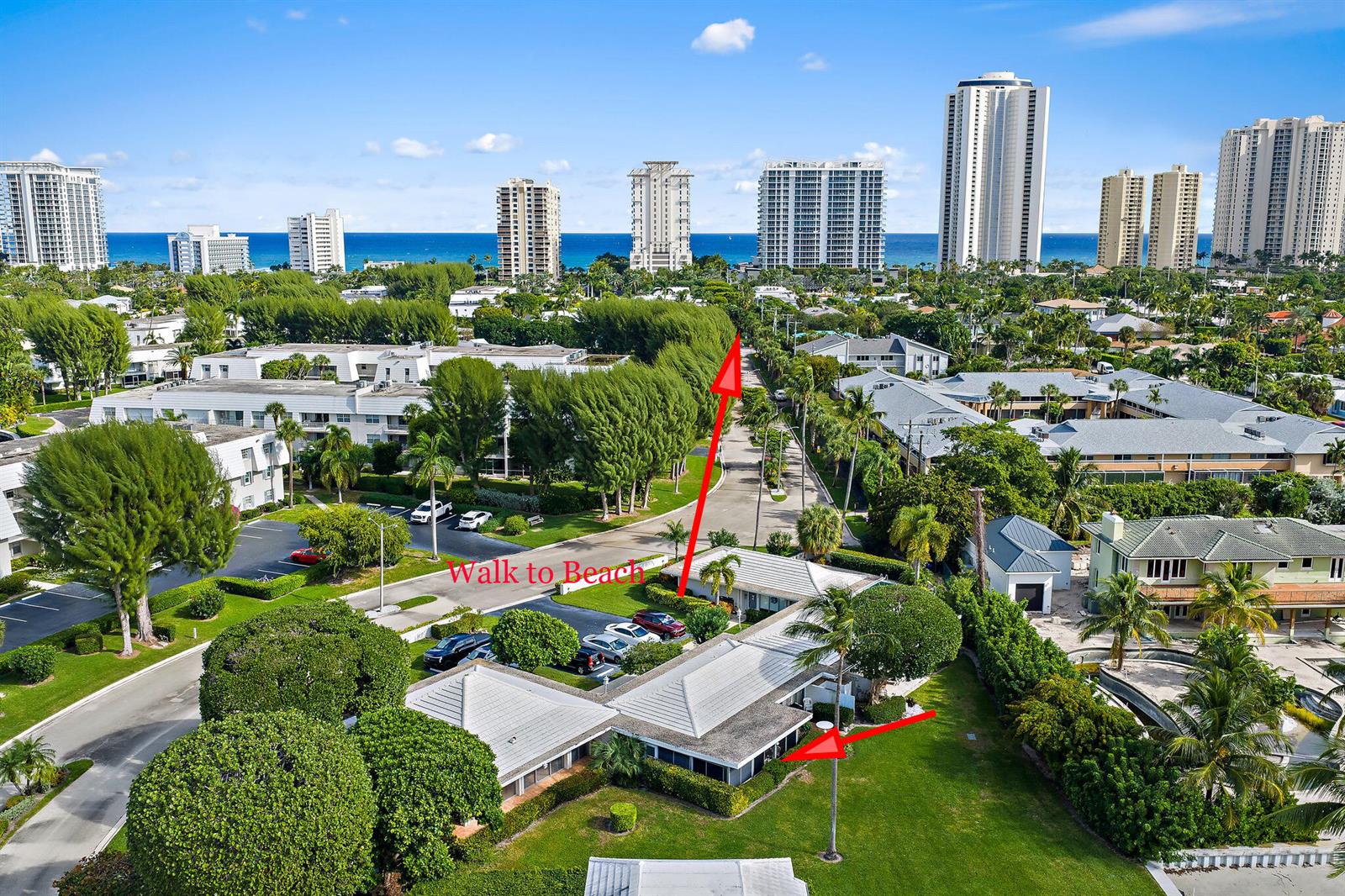 An aerial view shows a low-rise residential building surrounded by trees near a coastal city — 1145 Sugar Sands Boulevard, Singer Island FL 33404, SINGER ISLAND, FL